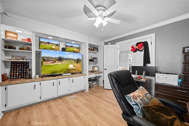 office area featuring ceiling fan, ornamental molding, light hardwood / wood-style floors, and built in features