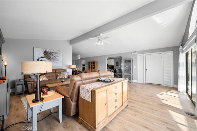 living room featuring ceiling fan, vaulted ceiling with beams, and light wood-type flooring