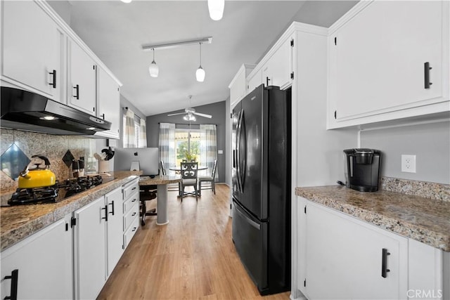 kitchen featuring white cabinets, hanging light fixtures, and black appliances