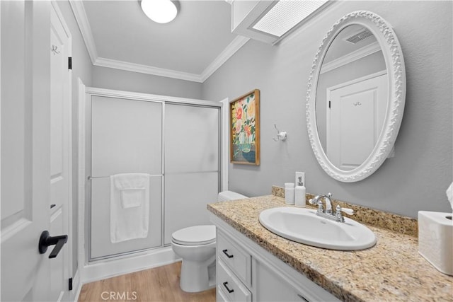 bathroom featuring toilet, vanity, wood-type flooring, and crown molding