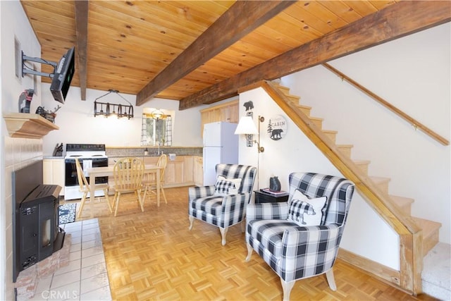 sitting room featuring beam ceiling, light parquet flooring, wooden ceiling, and sink