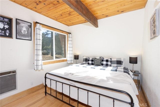 bedroom with beam ceiling, light wood-type flooring, heating unit, and wood ceiling