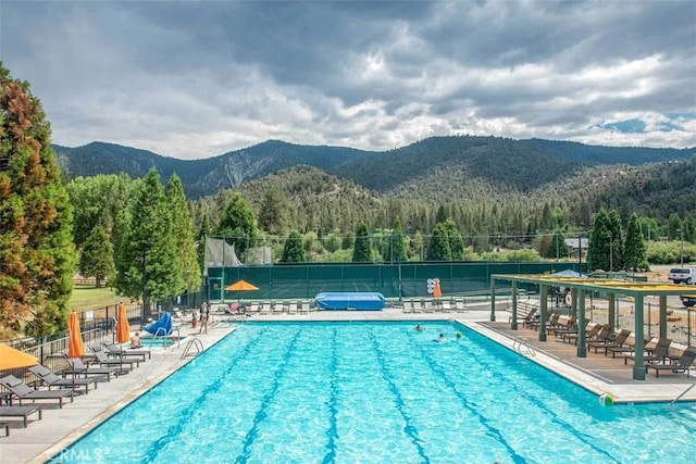 view of pool featuring a mountain view and a patio