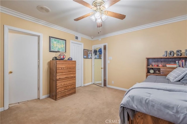 carpeted bedroom with ceiling fan and ornamental molding