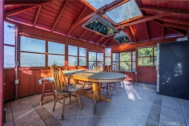 sunroom with plenty of natural light, wooden ceiling, and vaulted ceiling with skylight