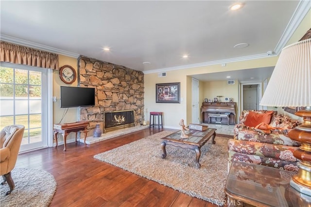 living room featuring a stone fireplace, crown molding, billiards, and hardwood / wood-style flooring