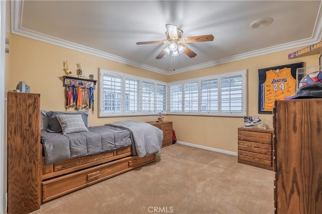 bedroom featuring ceiling fan, crown molding, and light carpet