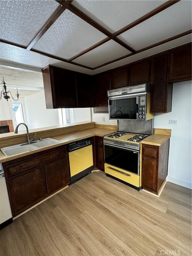 kitchen with white gas range, light hardwood / wood-style flooring, sink, and dishwasher