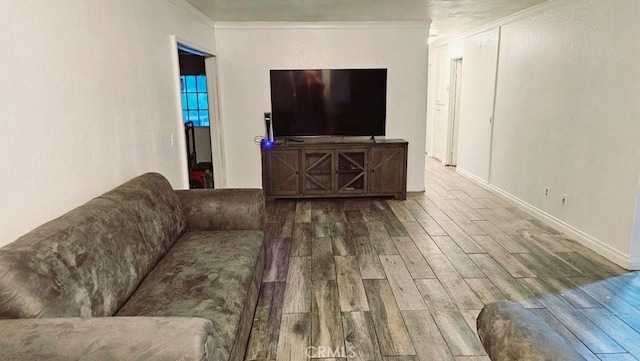 living room with wood-type flooring and ornamental molding