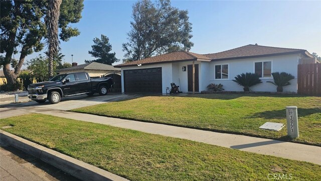 ranch-style house with a front yard and a garage