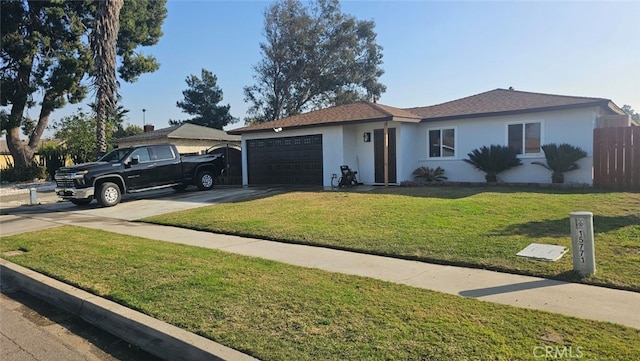 single story home featuring a garage and a front yard