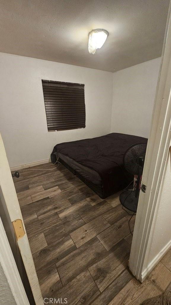 bedroom featuring dark wood-type flooring and a textured ceiling