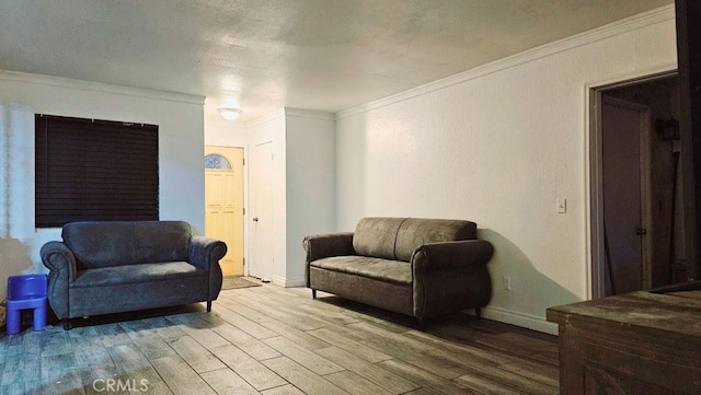 living room with hardwood / wood-style floors and ornamental molding