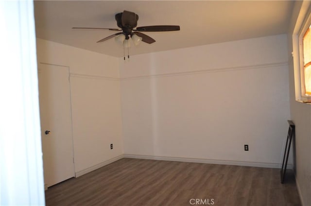 unfurnished room with dark hardwood / wood-style floors and ceiling fan