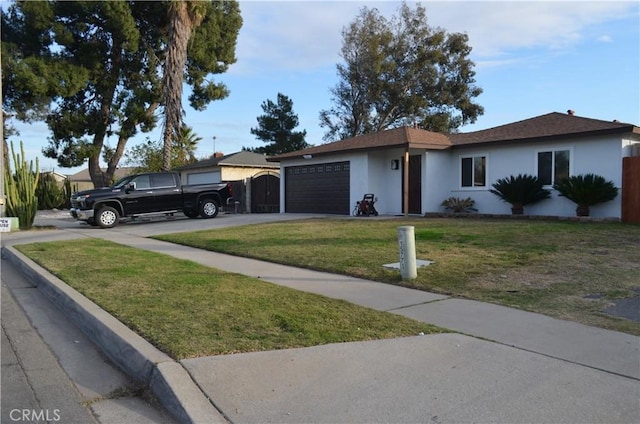 single story home with a garage and a front lawn