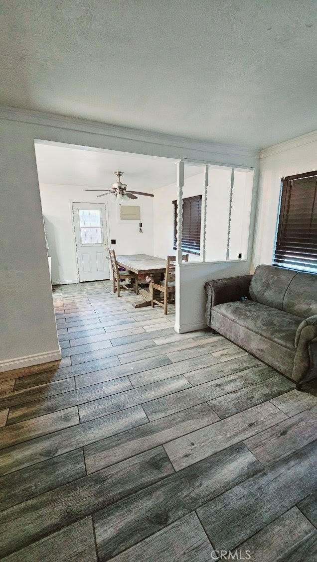 unfurnished living room featuring hardwood / wood-style flooring, ceiling fan, a wall mounted AC, and a textured ceiling