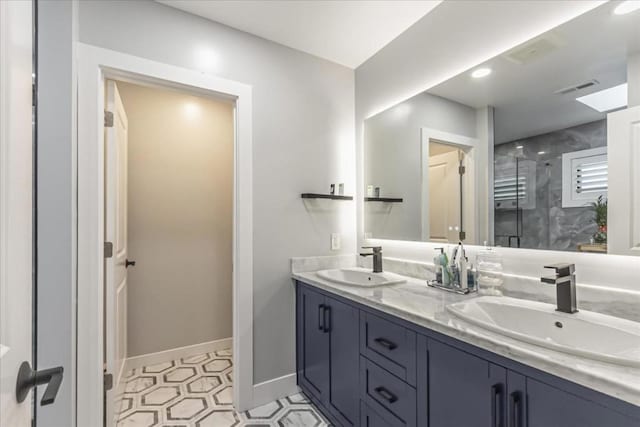 bathroom with a shower with door and vanity