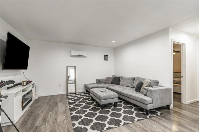 living room with wood-type flooring and a wall mounted air conditioner