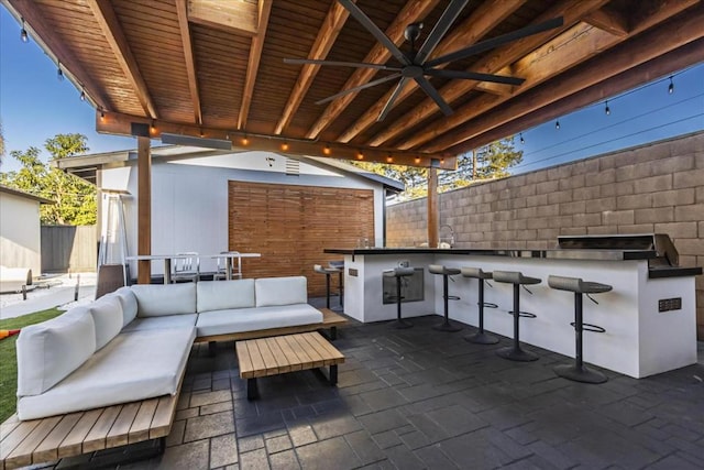 view of patio / terrace with ceiling fan, an outdoor hangout area, and exterior bar