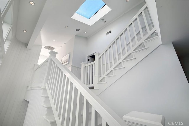 stairs featuring a skylight