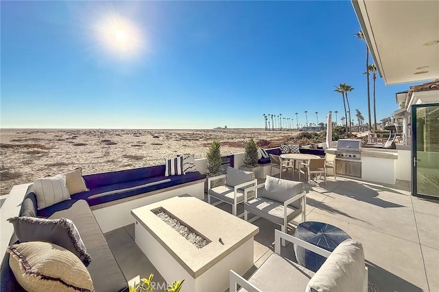 view of patio / terrace featuring area for grilling, a grill, and an outdoor living space with a fire pit