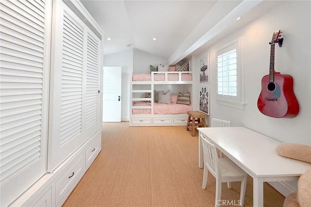 bedroom with light colored carpet and vaulted ceiling