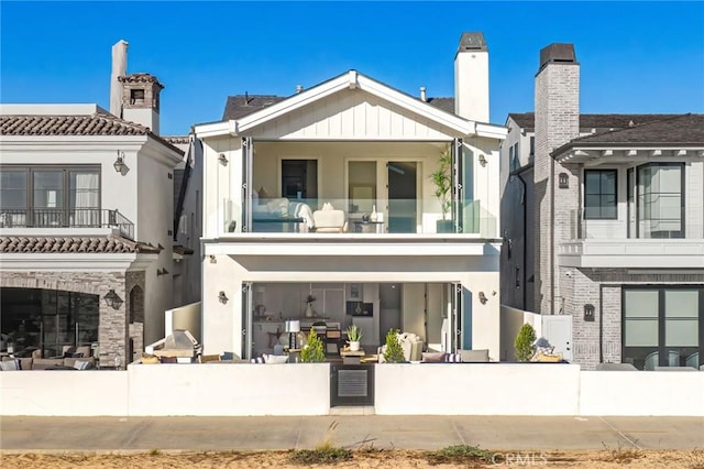 rear view of property with a balcony