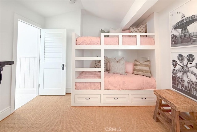 bedroom featuring light carpet and vaulted ceiling