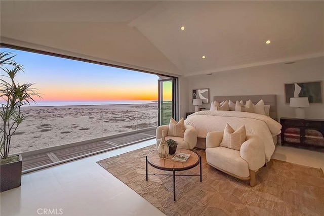 bedroom with a water view and vaulted ceiling