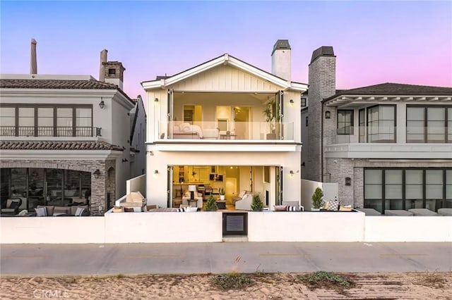 view of front of house featuring a balcony