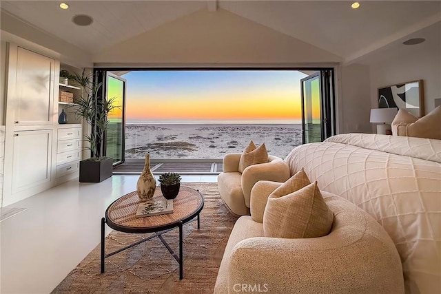 bedroom with vaulted ceiling with beams and a water view