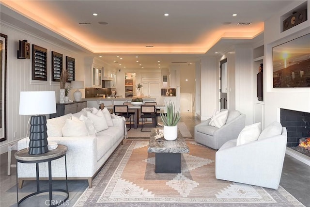 living room featuring a raised ceiling