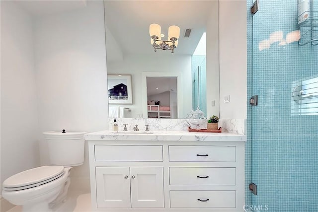 bathroom featuring toilet, vanity, an inviting chandelier, and walk in shower