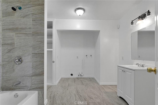 bathroom featuring tiled shower / bath combo and vanity