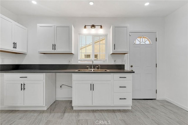 kitchen featuring sink, a wealth of natural light, and white cabinets