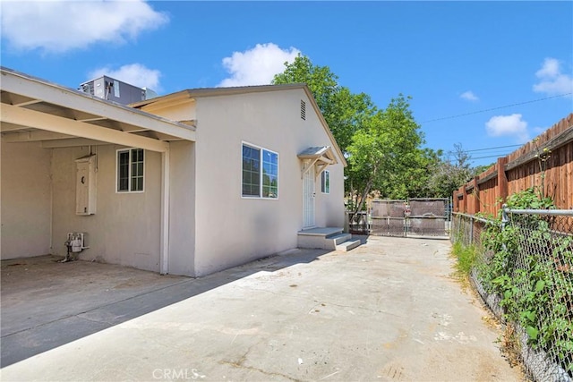 view of side of home with a patio area