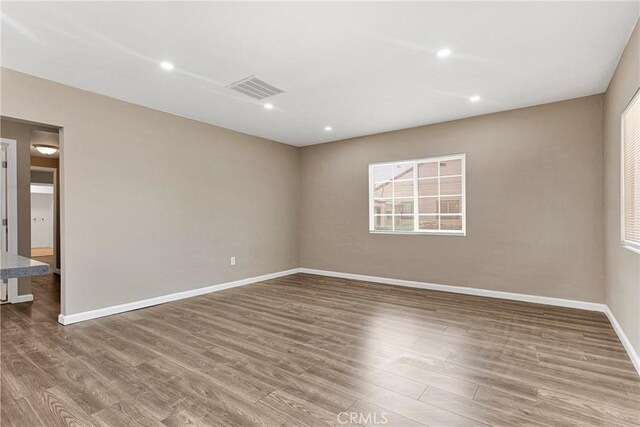 unfurnished room featuring hardwood / wood-style floors