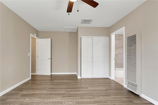 unfurnished bedroom with hardwood / wood-style flooring, a closet, and ceiling fan