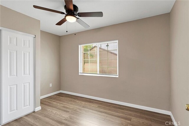 unfurnished room featuring light wood-type flooring and ceiling fan