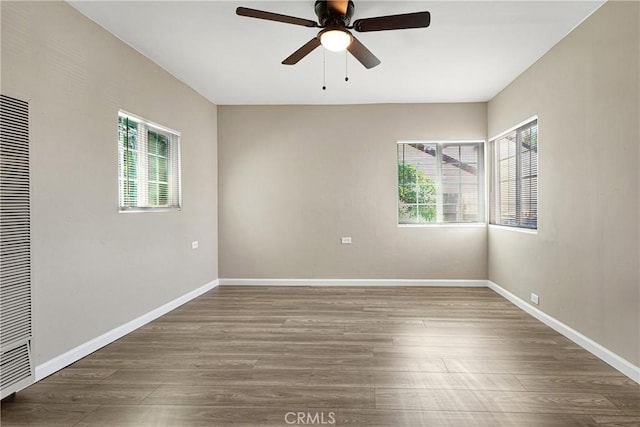 empty room with ceiling fan and dark wood-type flooring