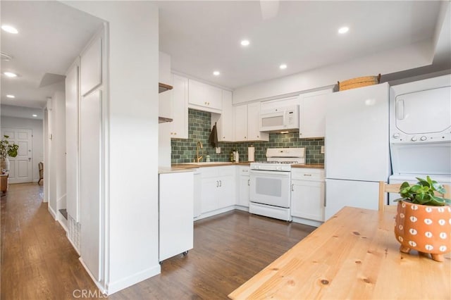 4698 Heil Ave Unit 23C, Huntington Beach, CA 92649 - kitchen with white appliances, stacked washer / dryer, butcher block counters, dark wood-style flooring, and backsplash