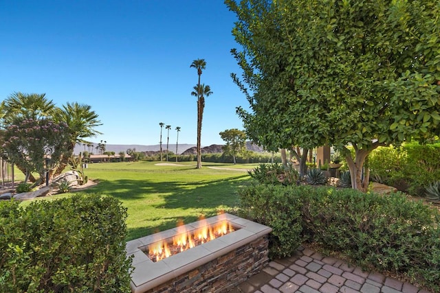 surrounding community featuring a yard and an outdoor fire pit