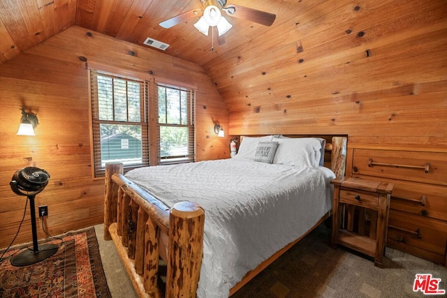 bedroom featuring dark colored carpet, lofted ceiling, wood walls, and wood ceiling