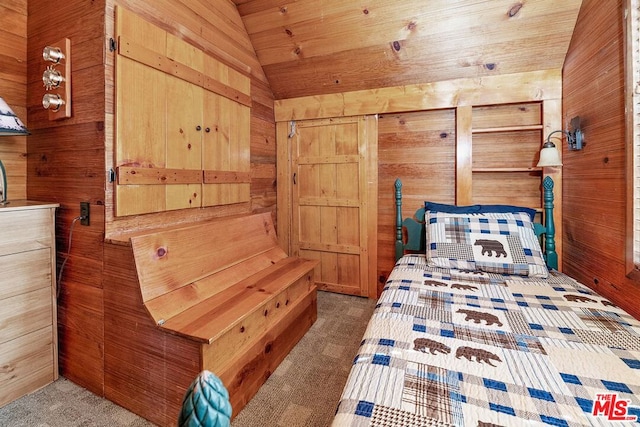 bedroom featuring dark colored carpet, vaulted ceiling, and wooden walls