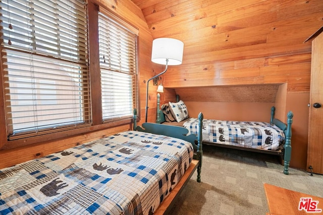 bedroom featuring wooden ceiling, carpet floors, wooden walls, and vaulted ceiling