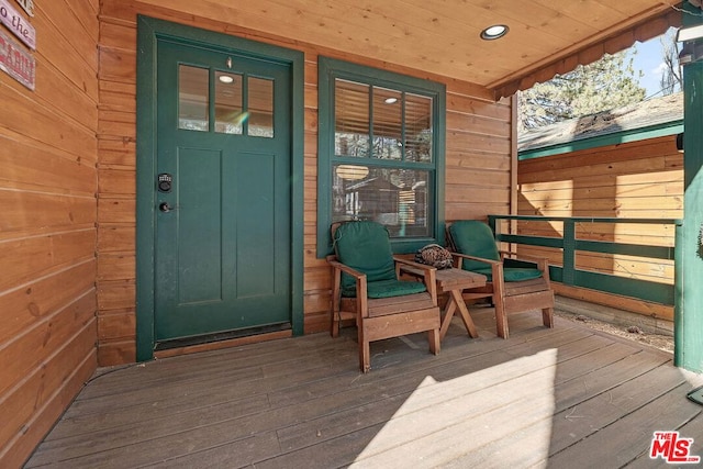 view of exterior entry with covered porch