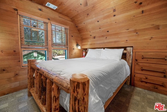 carpeted bedroom featuring ceiling fan, wood walls, lofted ceiling, and wooden ceiling