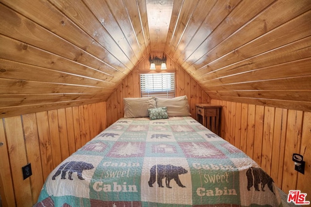 unfurnished bedroom featuring wood walls, wood ceiling, and lofted ceiling