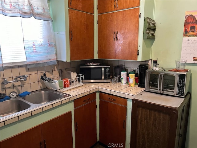 kitchen featuring backsplash and sink