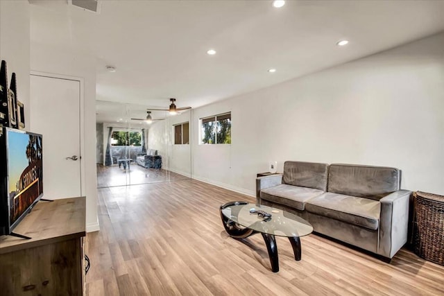 living room with ceiling fan and light wood-type flooring